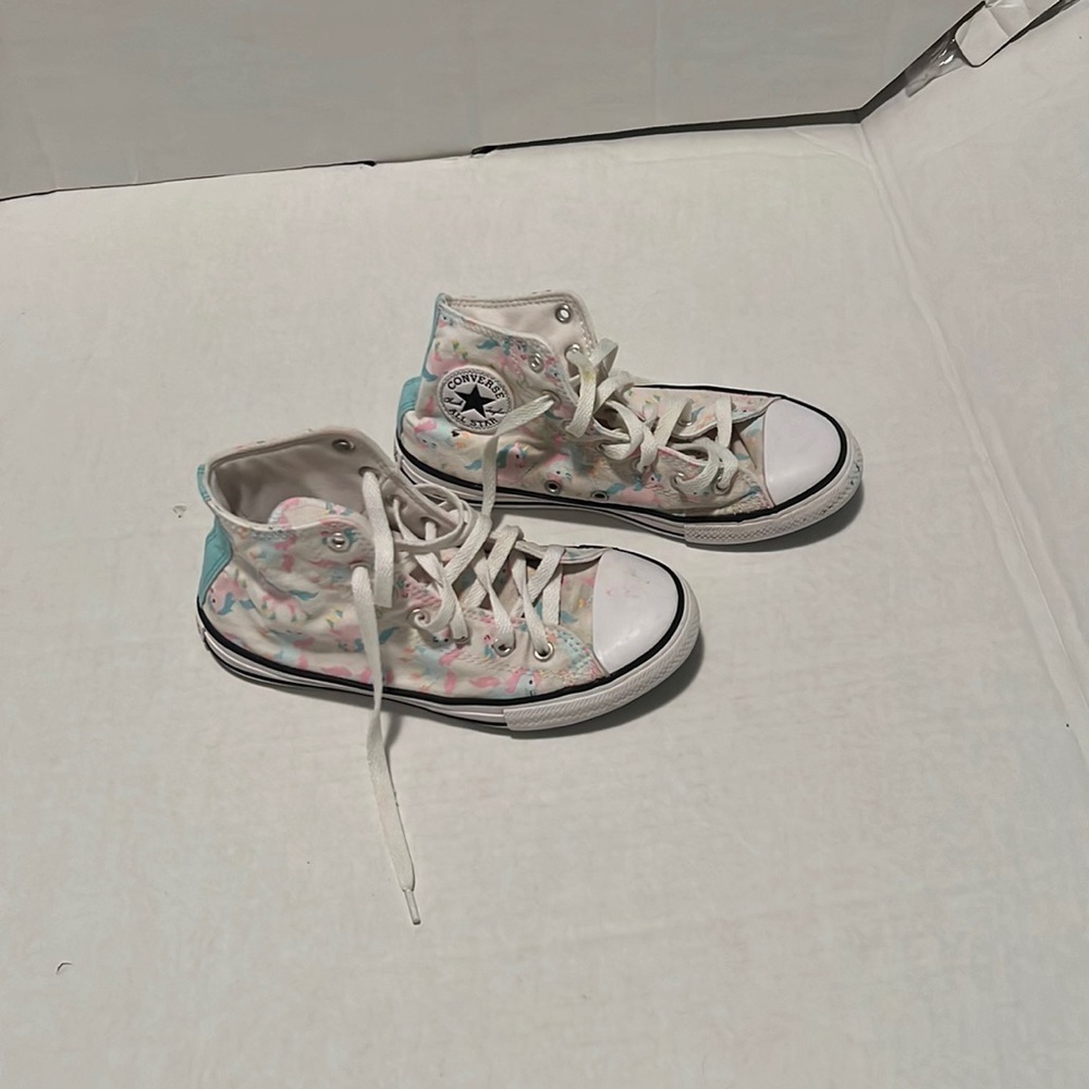 Converse unicorn high top tennis shoe.